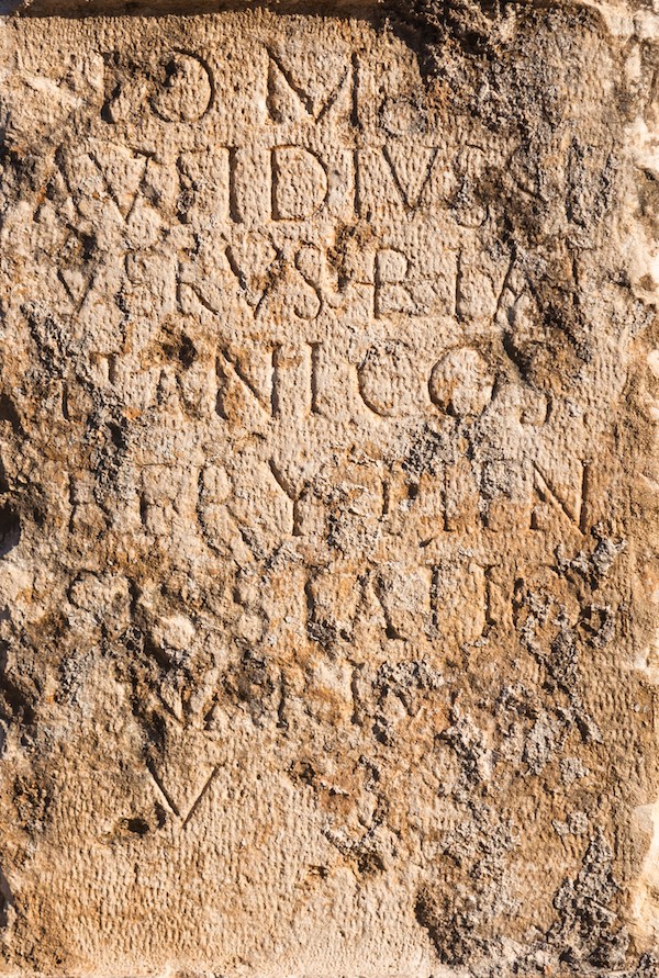 Pillar of stone with ancient Roman text in Byblos, Lebanon